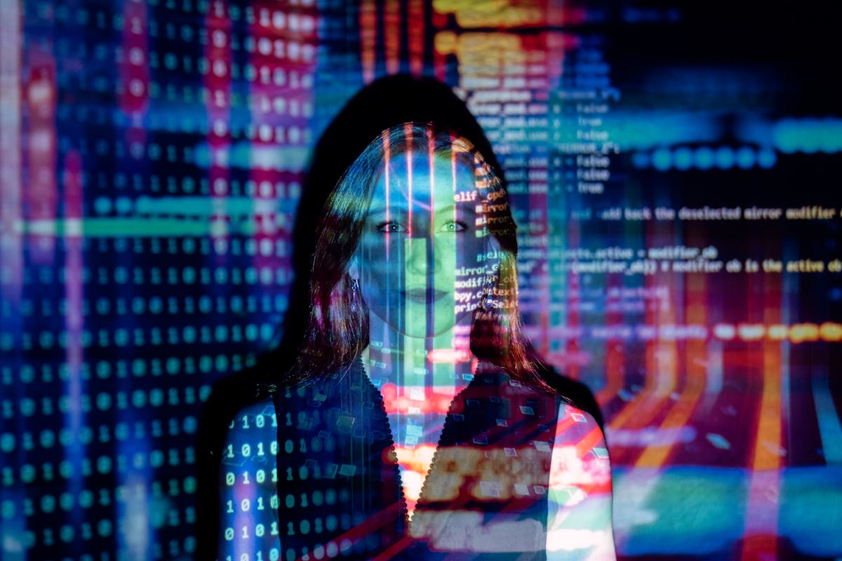 Person with digital code projected on face, symbolizing technology and data concepts.