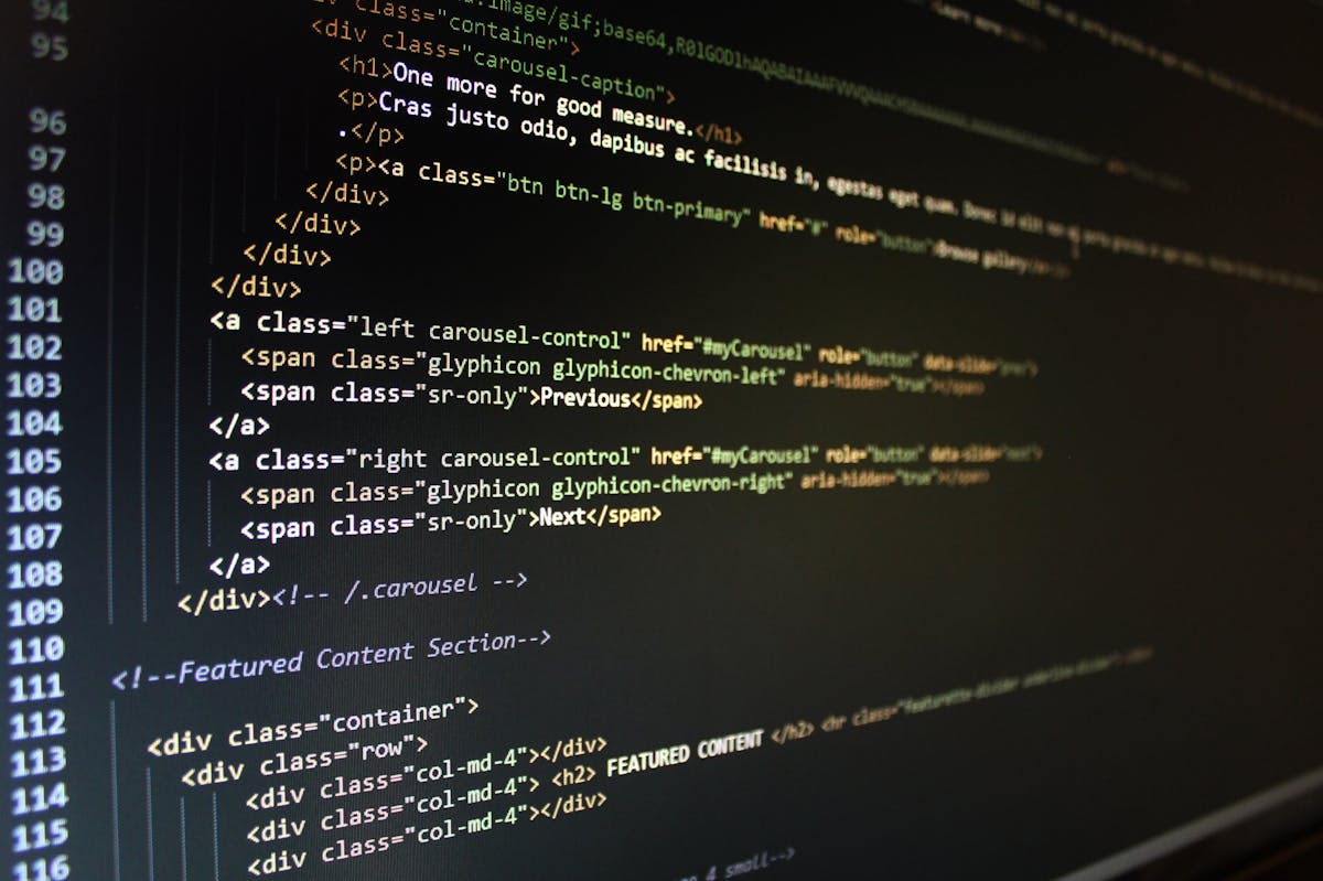 HTML code displayed on a computer screen in a dark mode development environment.